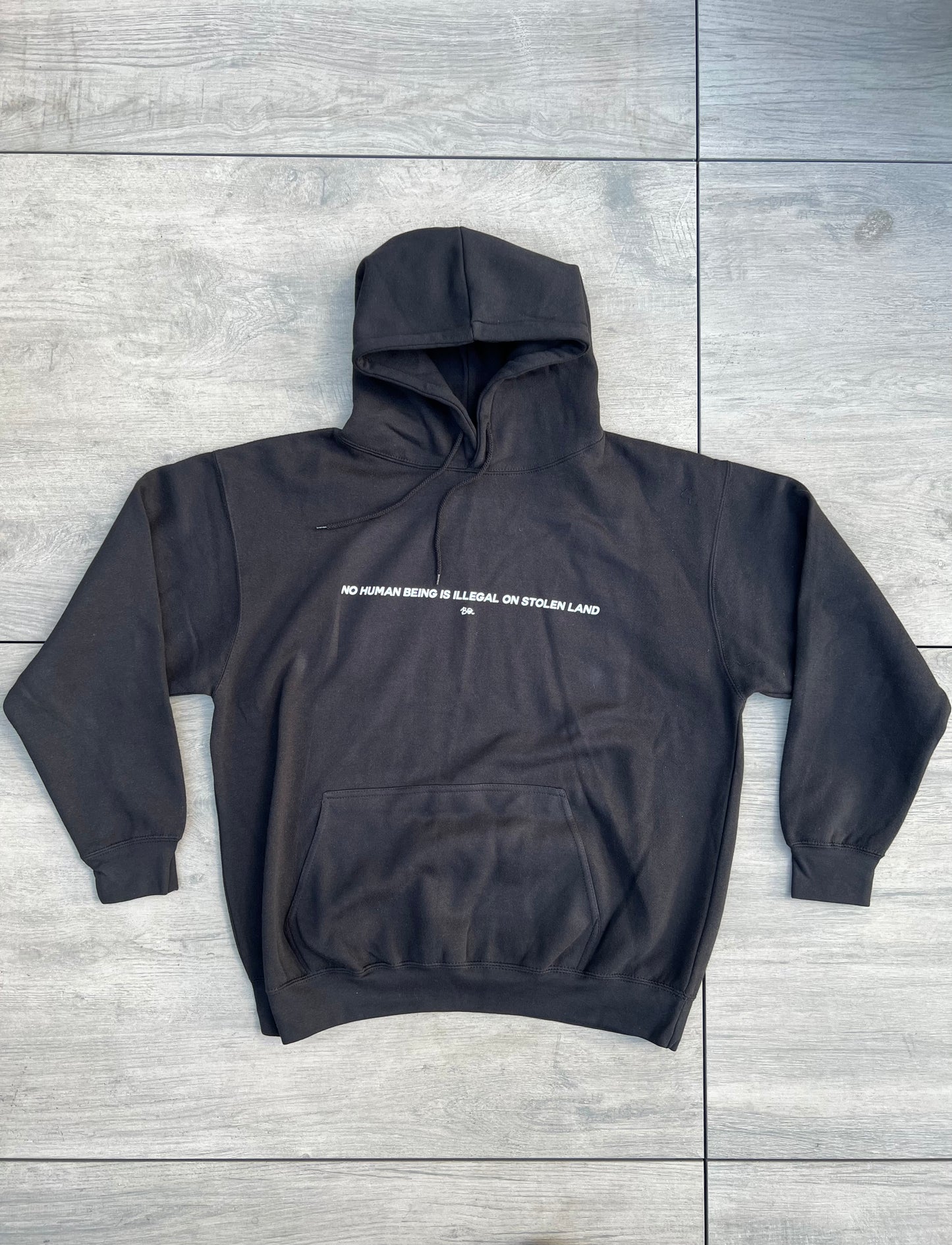 “No Human Being is Illegal on Stolen Land” Essential hoodie